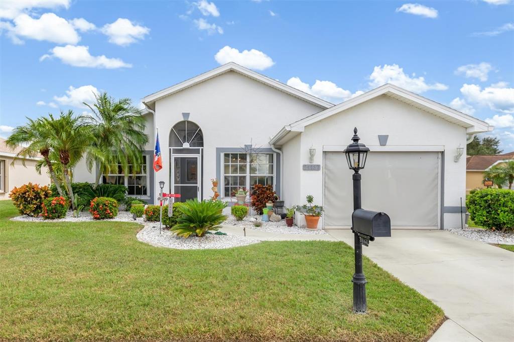 24167 Buckingham Way Punta Gorda, FL 33980 - Photo 2 of 42 a front view of a house with garden and porch