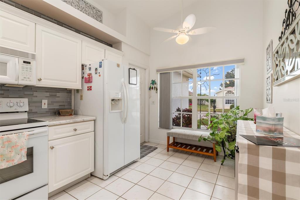 24167 Buckingham Way Punta Gorda, FL 33980 - Photo 10 of 42 a kitchen with furniture and a refrigerator