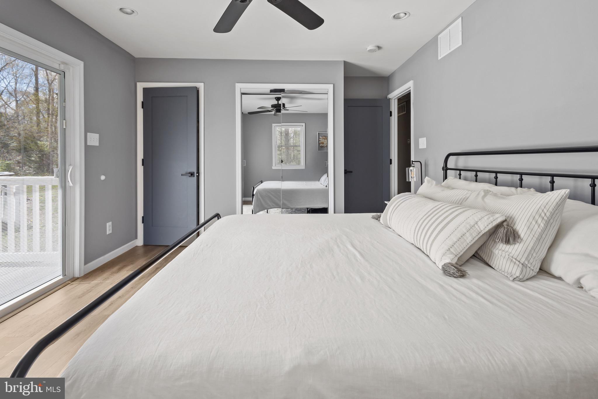 153 Crystal Road Elmer, NJ 08318 - Photo 14 of 29 a bedroom with a large bed and a chandelier