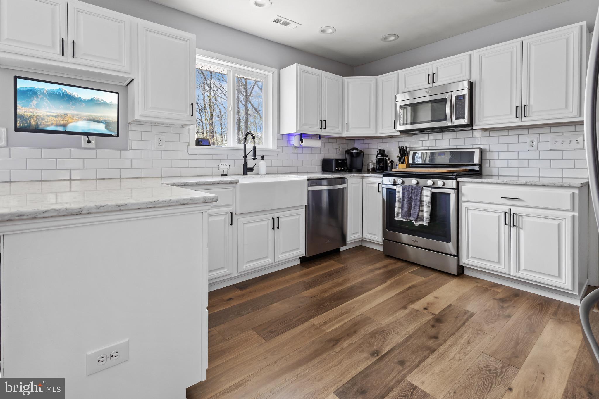 153 Crystal Road Elmer, NJ 08318 - Photo 5 of 29 a kitchen with stainless steel appliances granite countertop a stove sink and cabinets