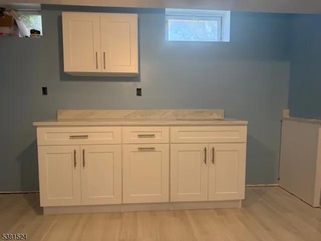 a view of white cabinets with wooden floor