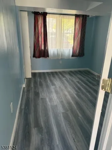 a view of wooden floor with windows