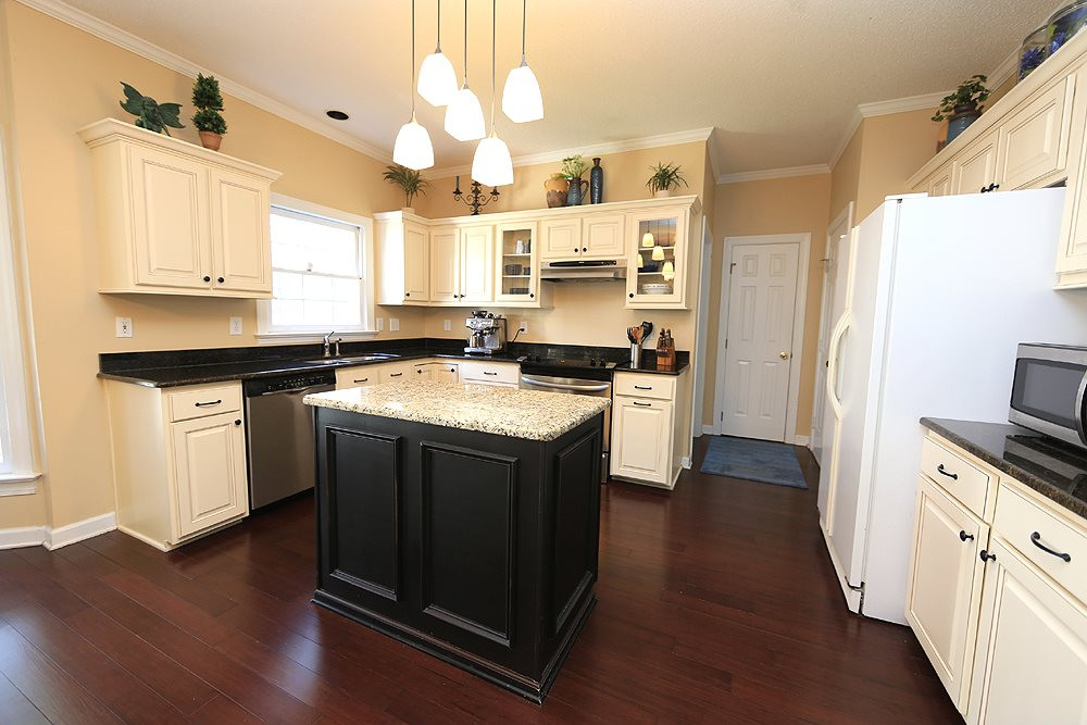 5628 Raddington Street Raleigh, NC 27613 - Photo 9 of 25 Beautifully updated kitchen with center island, granite counters, and hardwood floors. Kitchen