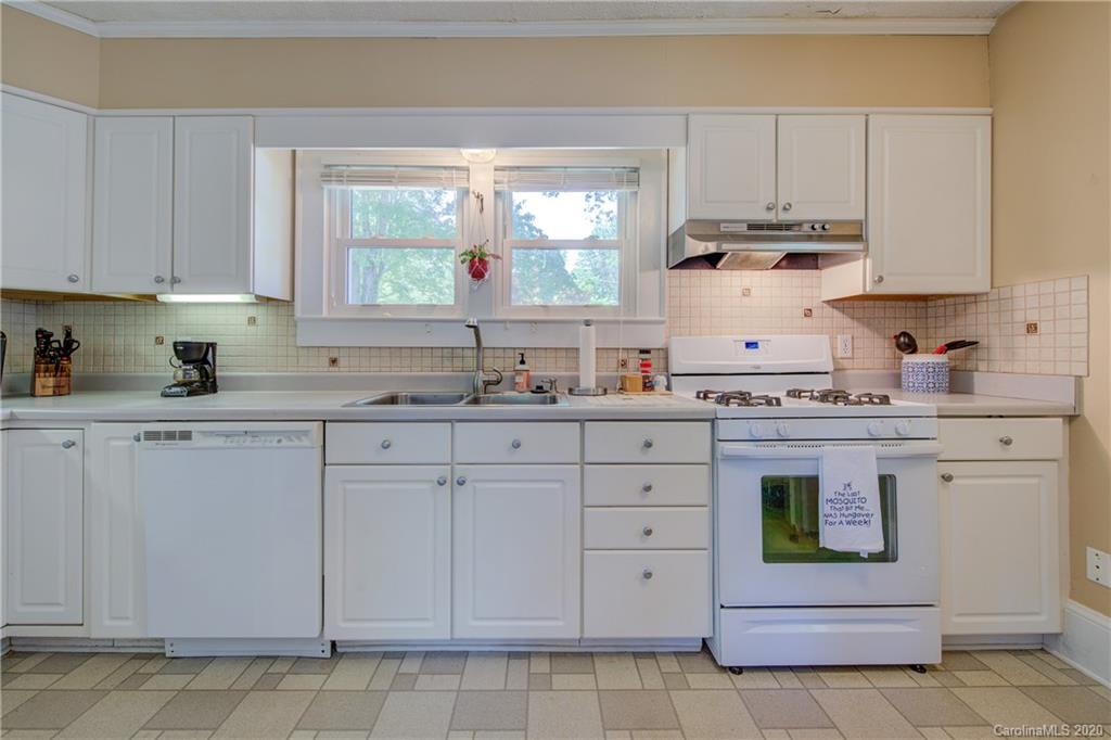 173 Callahan Street Rutherfordton, NC 28139 - Photo 14 of 25 a kitchen with cabinets appliances a sink and a window