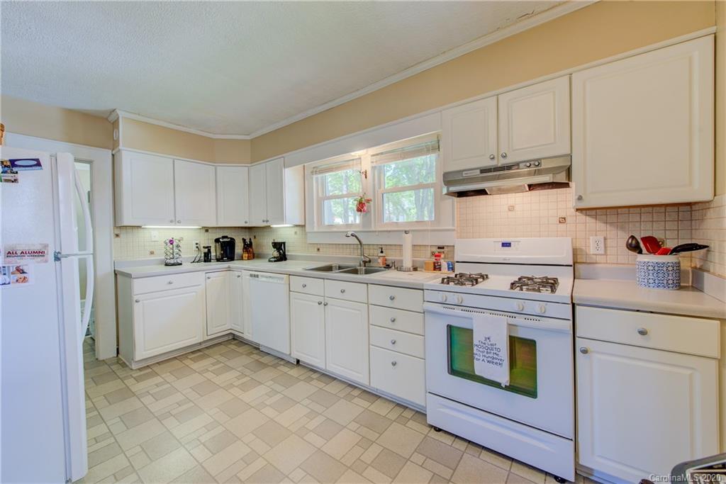 173 Callahan Street Rutherfordton, NC 28139 - Photo 15 of 25 a kitchen with granite countertop white cabinets and white appliances