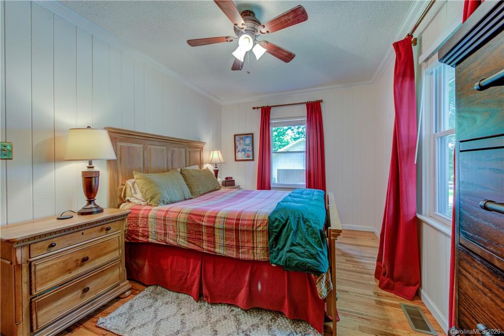 173 Callahan Street Rutherfordton, NC 28139 - Photo 20 of 25 a bedroom with a bed and a chandelier