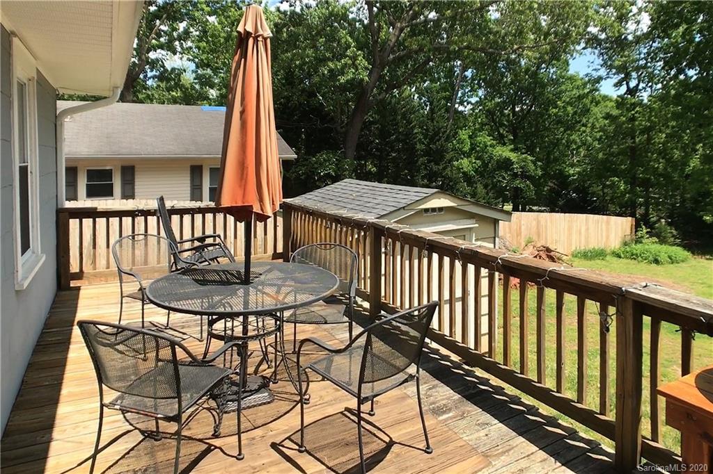 173 Callahan Street Rutherfordton, NC 28139 - Photo 24 of 25 a view of a patio with table and chairs and wooden floor