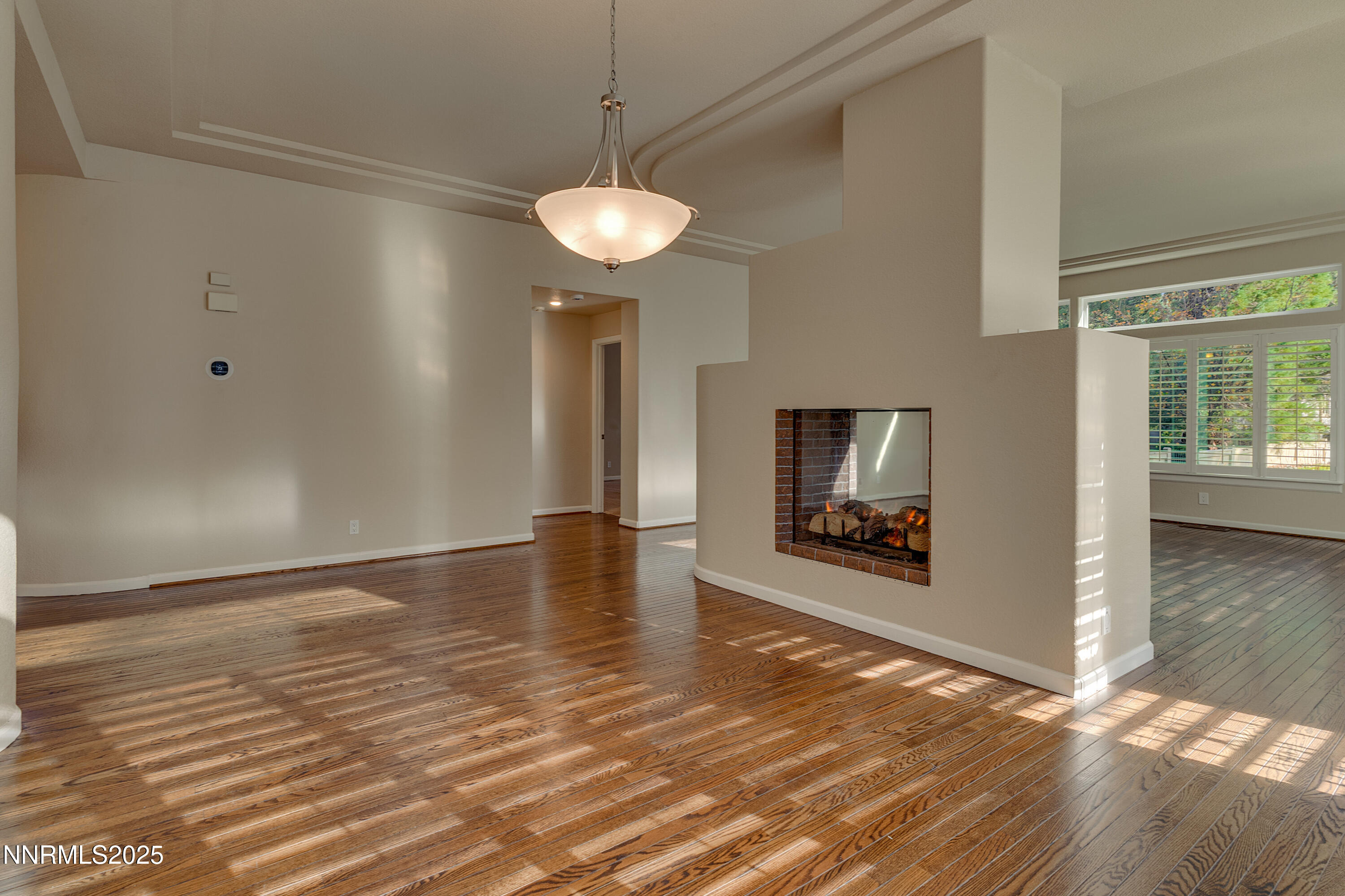 4052 Caughlin Creek Road Reno, NV 89519 - Photo 16 of 37 an empty room with wooden floor and windows