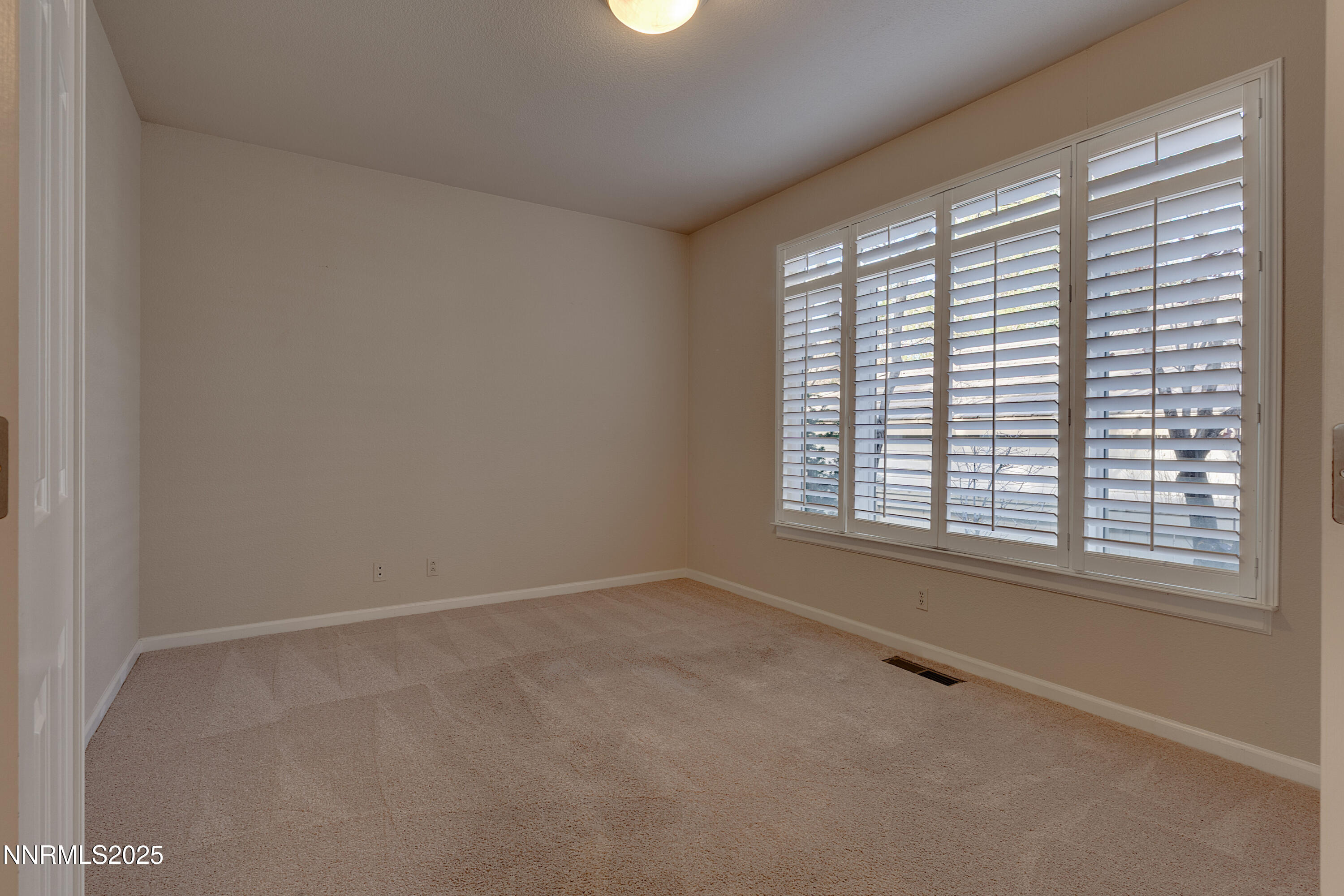 4052 Caughlin Creek Road Reno, NV 89519 - Photo 33 of 37 an empty room with a window