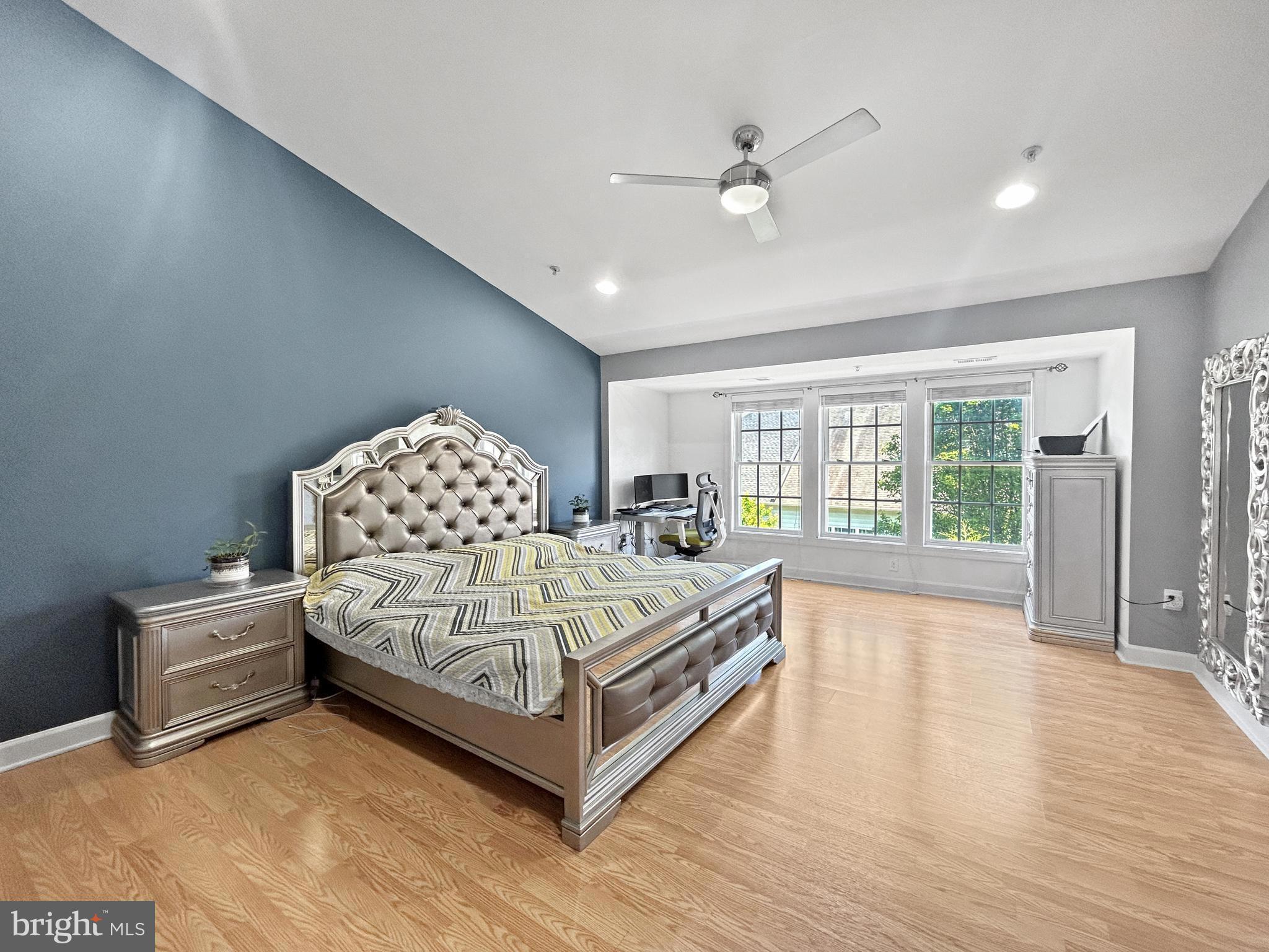 913 Highland Ridge Avenue Gaithersburg, MD 20878 - Photo 17 of 38 a spacious bedroom with a bed and a large window