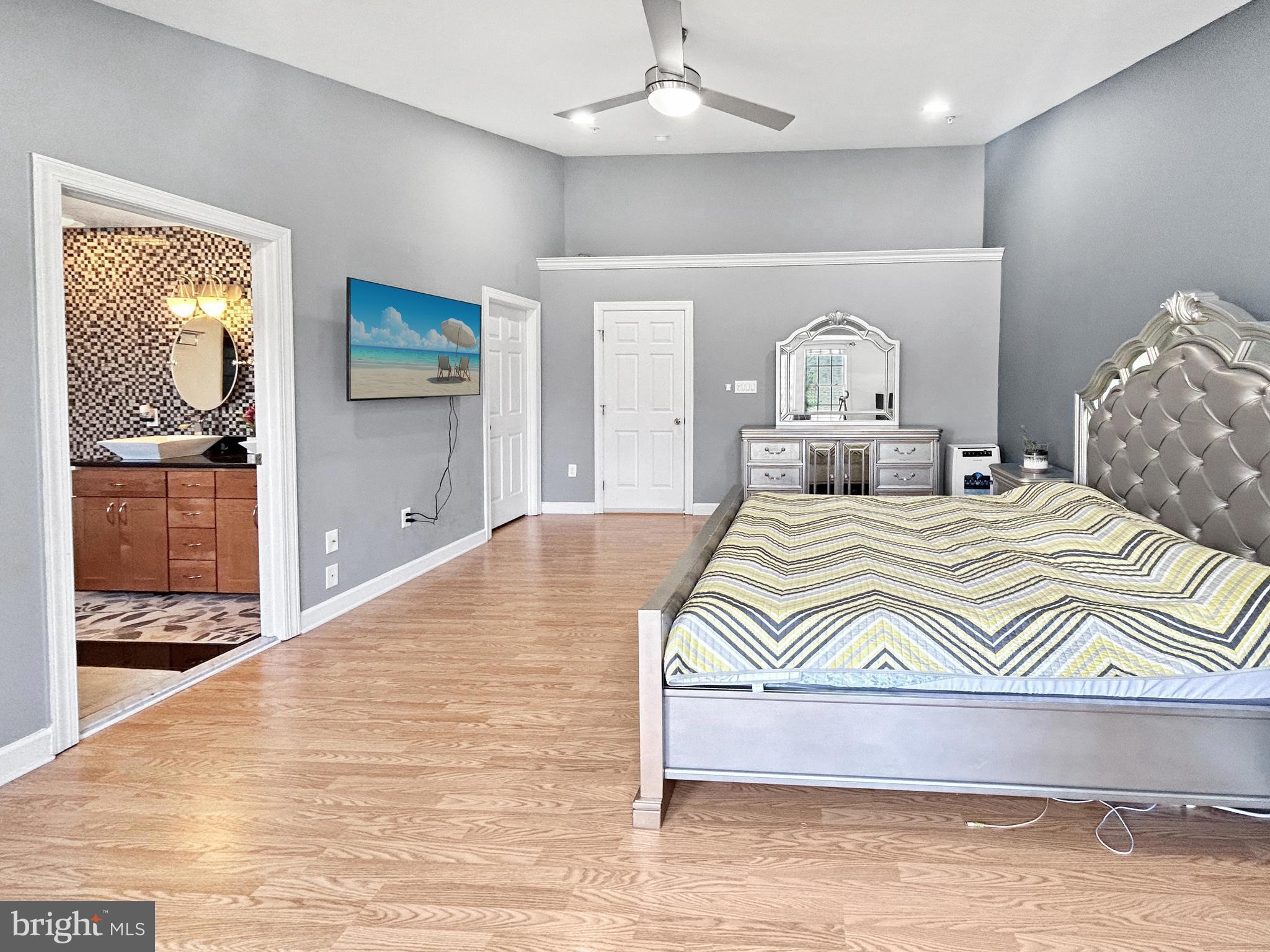 913 Highland Ridge Avenue Gaithersburg, MD 20878 - Photo 18 of 38 a bedroom with a bed and a view of living room
