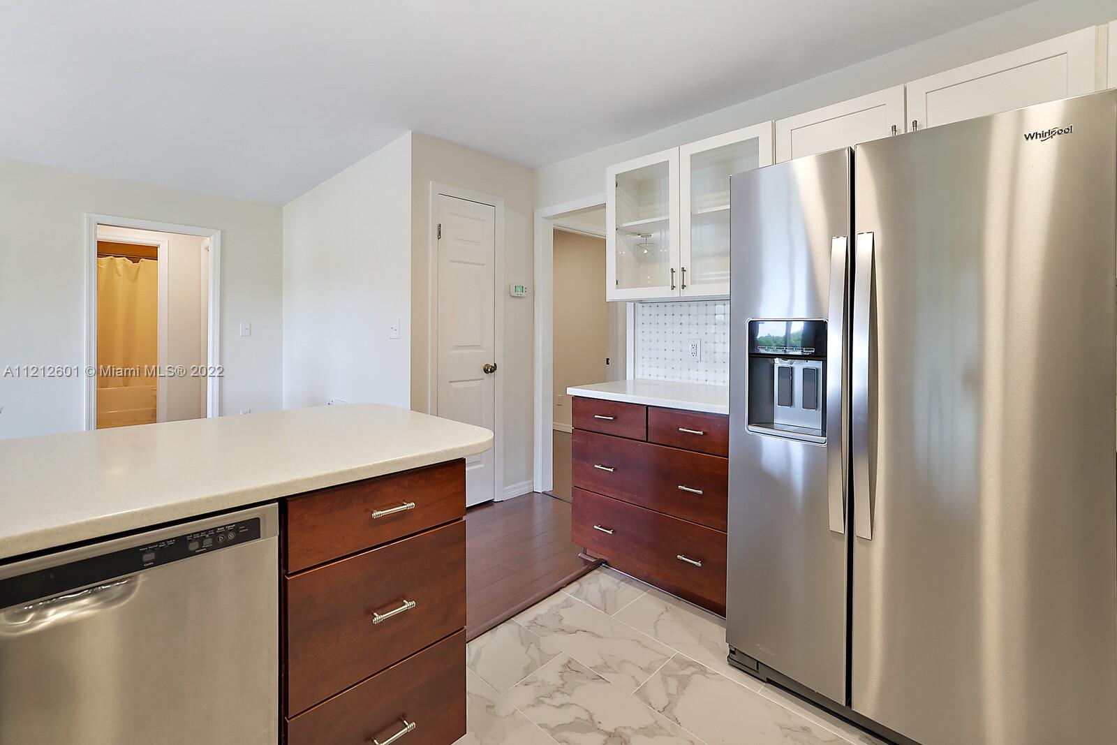 3052 Pine Cove Place Eustis, FL 32726 - Photo 11 of 32 a kitchen with a refrigerator and countertop