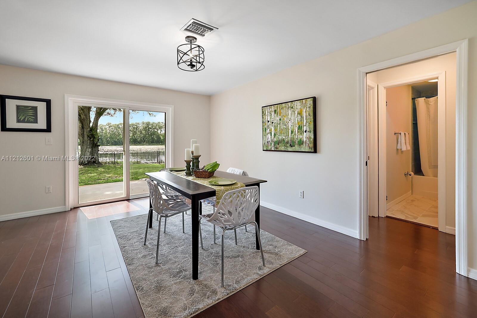 3052 Pine Cove Place Eustis, FL 32726 - Photo 12 of 32 a view of a dining room with furniture window and wooden floor