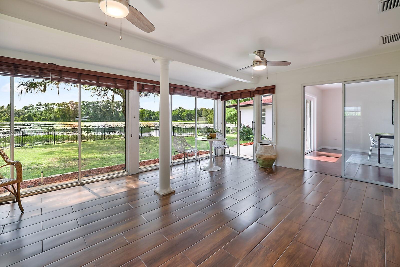 3052 Pine Cove Place Eustis, FL 32726 - Photo 18 of 32 a living room with hardwood floor and large windows