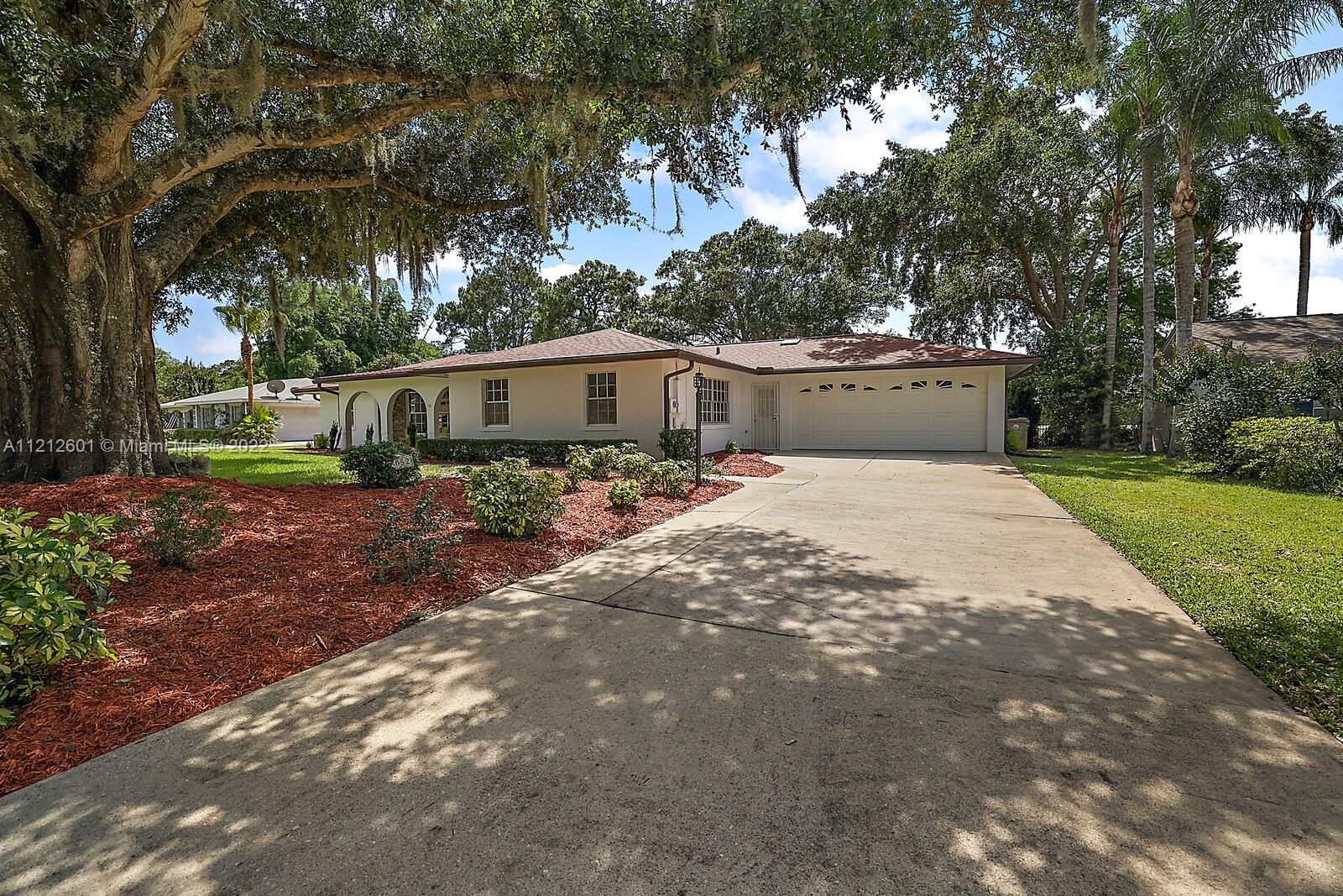 3052 Pine Cove Place Eustis, FL 32726 - Photo 2 of 32 a view of a house with a yard and sitting area