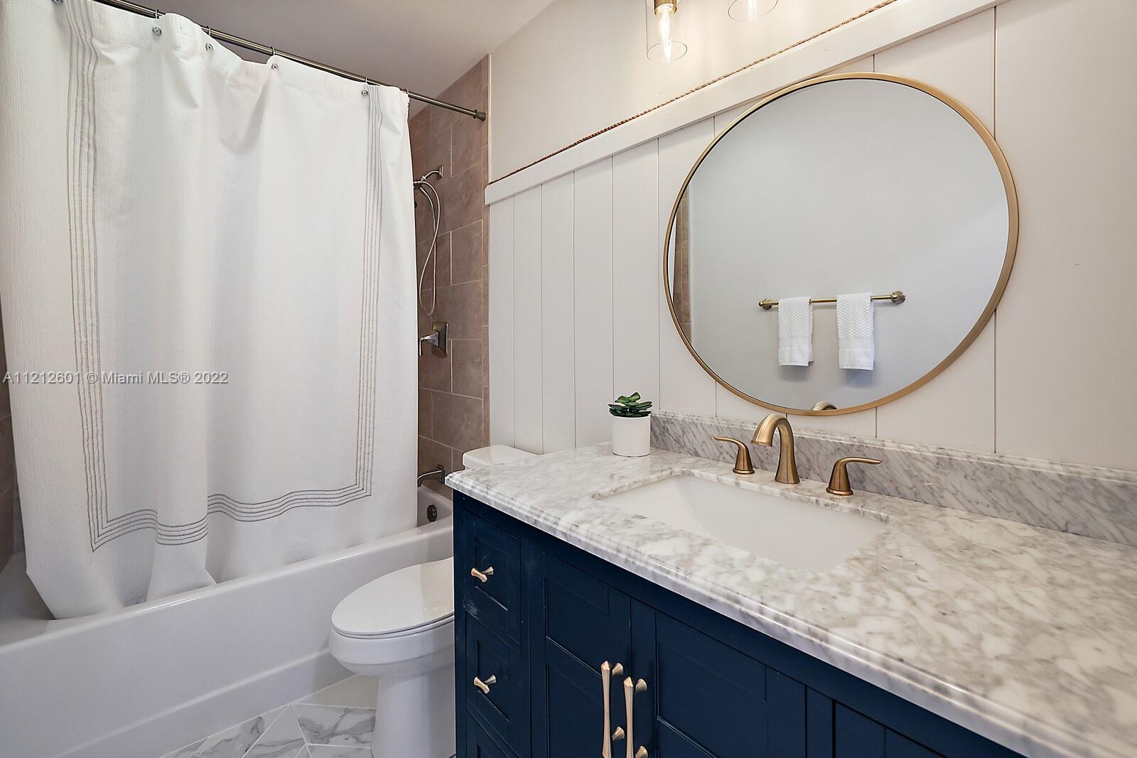 3052 Pine Cove Place Eustis, FL 32726 - Photo 22 of 32 a bathroom with a granite countertop sink a toilet and a mirror