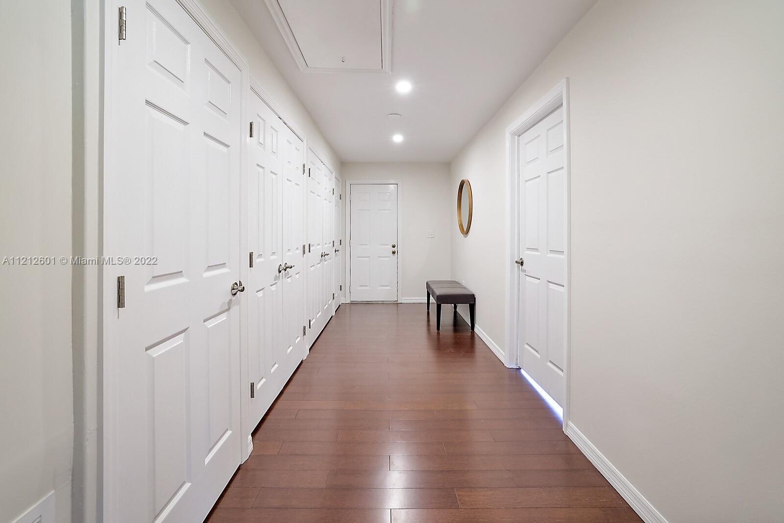 3052 Pine Cove Place Eustis, FL 32726 - Photo 23 of 32 a hallway with wooden floor and staircase