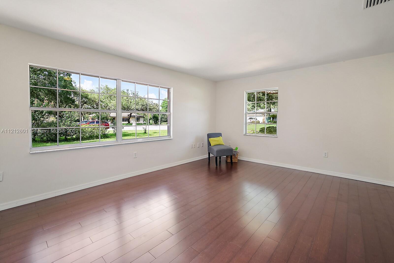 3052 Pine Cove Place Eustis, FL 32726 - Photo 24 of 32 a view of an empty room with wooden floor and a window