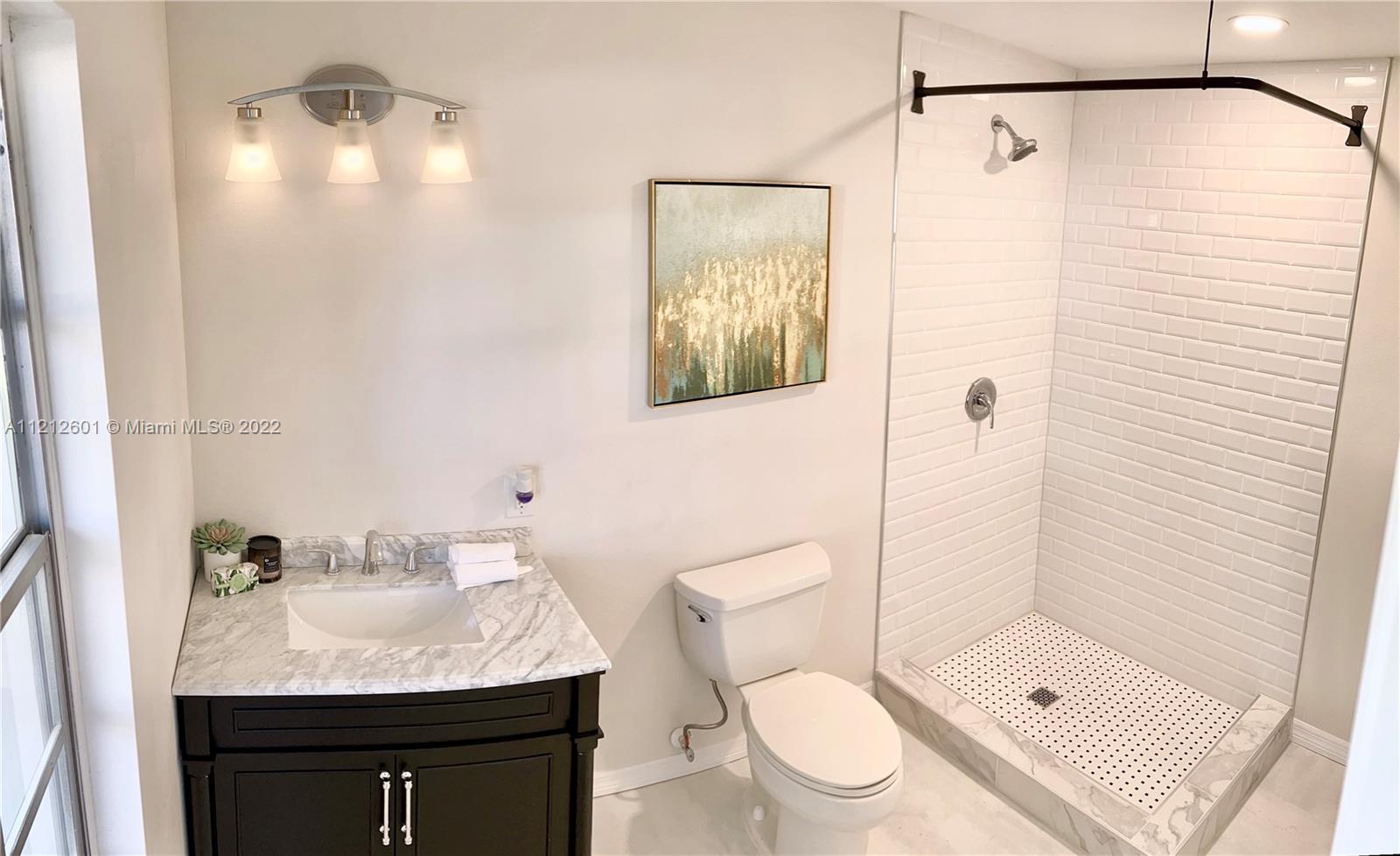 3052 Pine Cove Place Eustis, FL 32726 - Photo 25 of 32 a bathroom with a granite countertop sink a toilet and shower