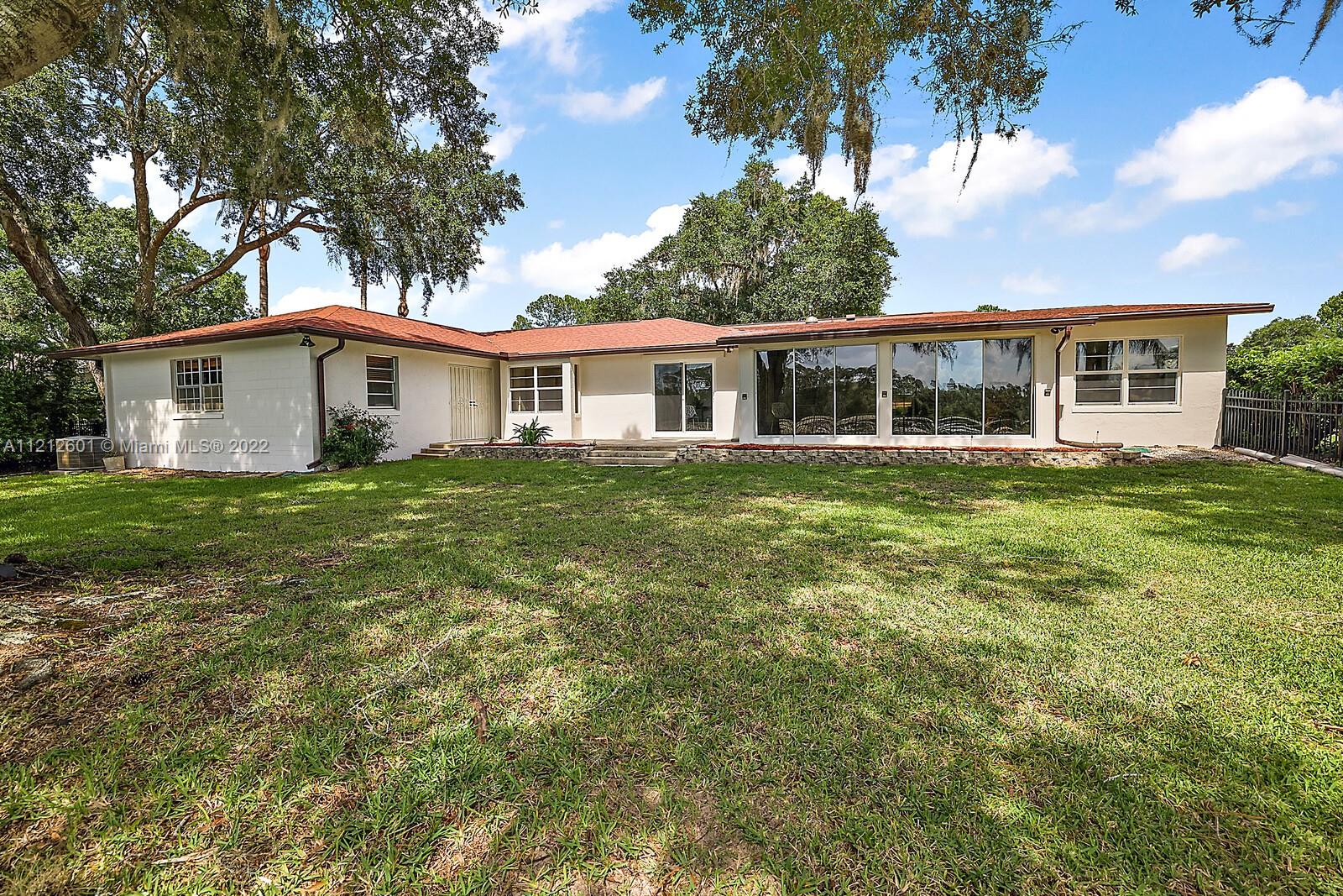 3052 Pine Cove Place Eustis, FL 32726 - Photo 28 of 32 a view of a house with a yard
