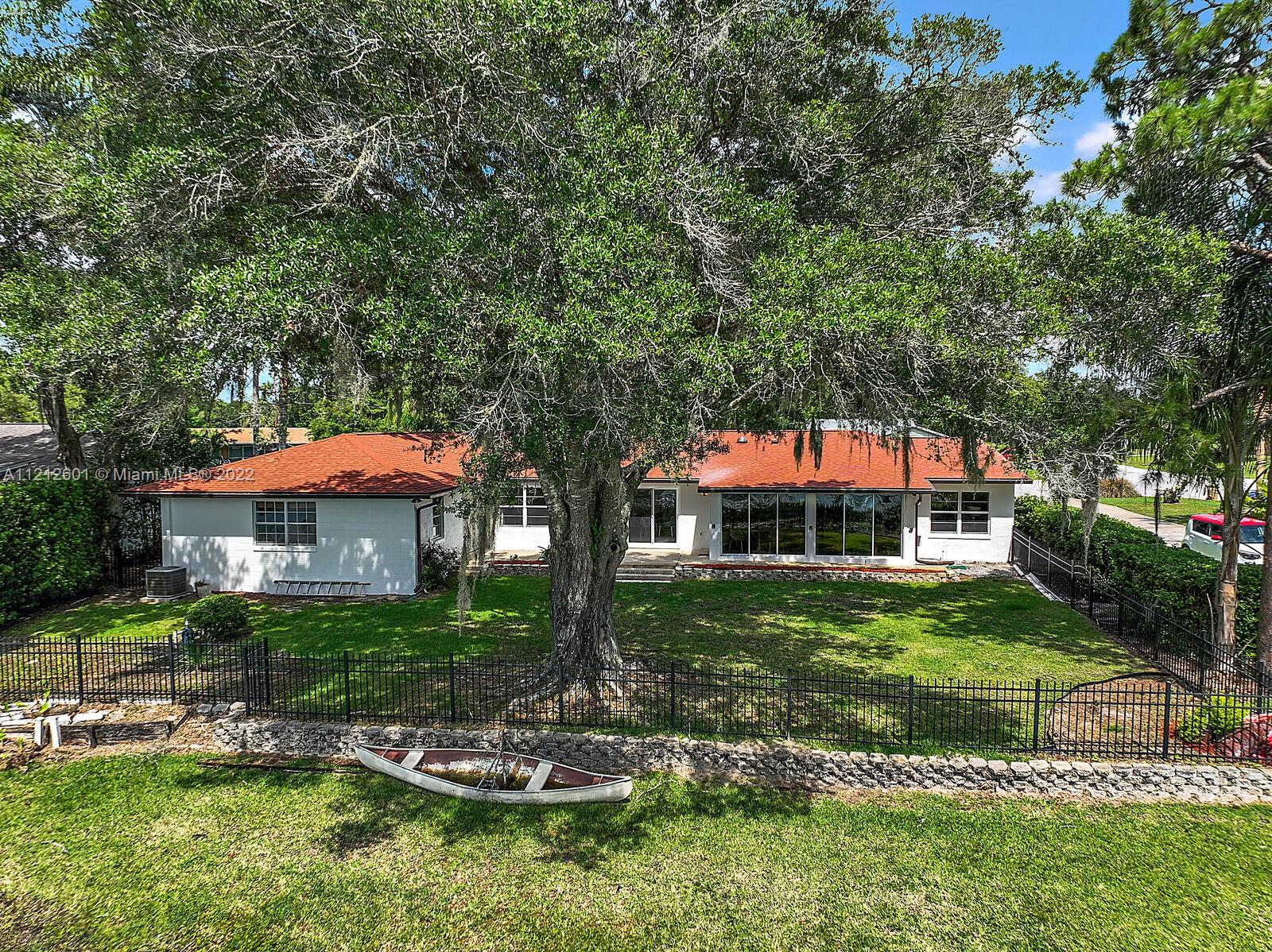 3052 Pine Cove Place Eustis, FL 32726 - Photo 29 of 32 a view of a house with a yard and sitting area