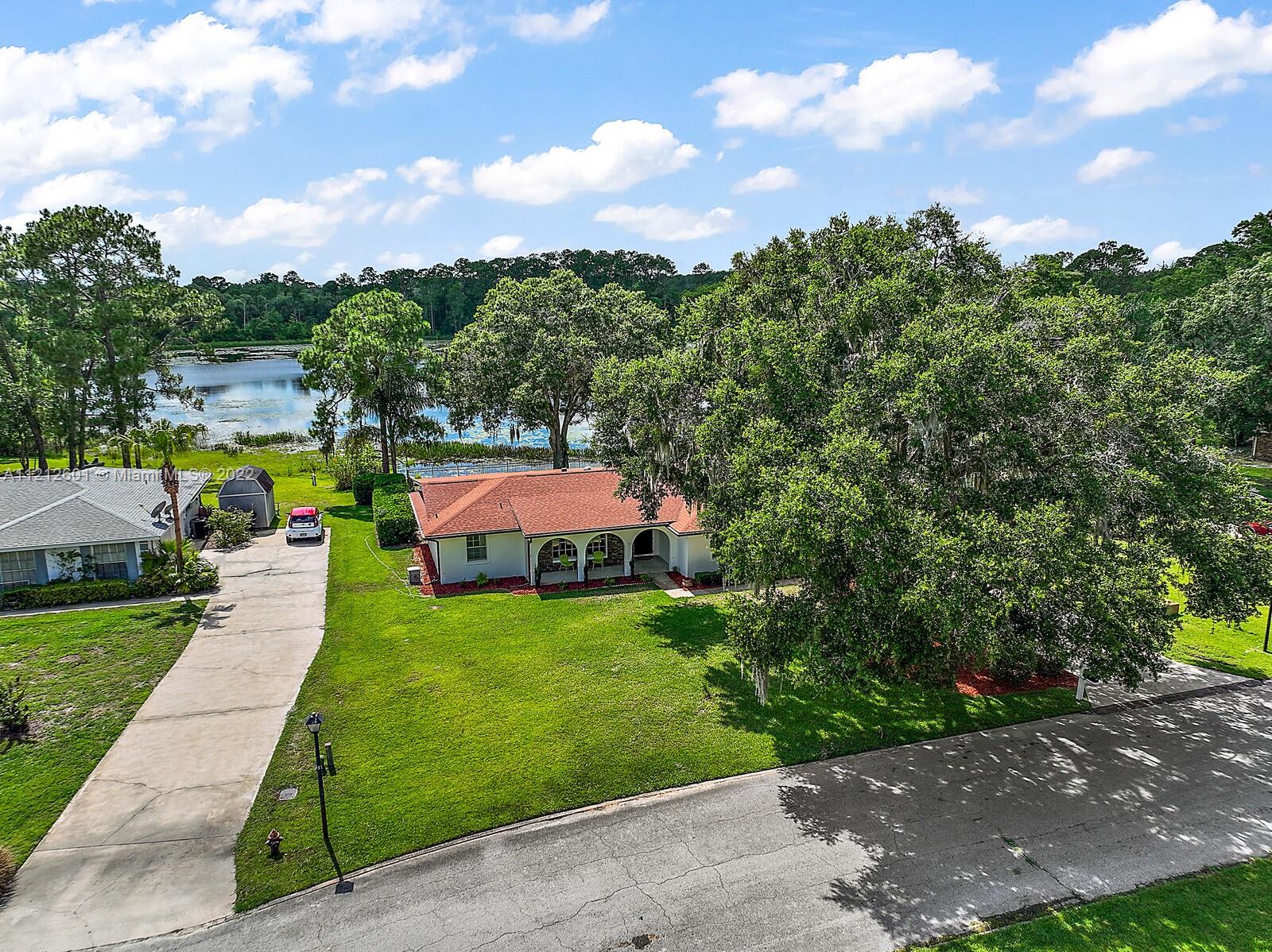 3052 Pine Cove Place Eustis, FL 32726 - Photo 32 of 32 a view of a garden with swimming pool