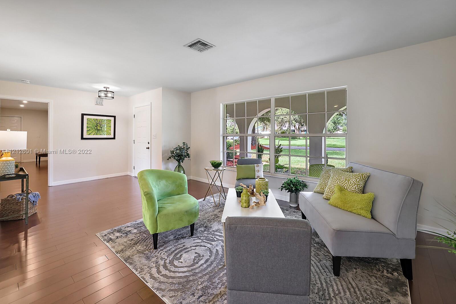 3052 Pine Cove Place Eustis, FL 32726 - Photo 6 of 32 a living room with furniture and a large window