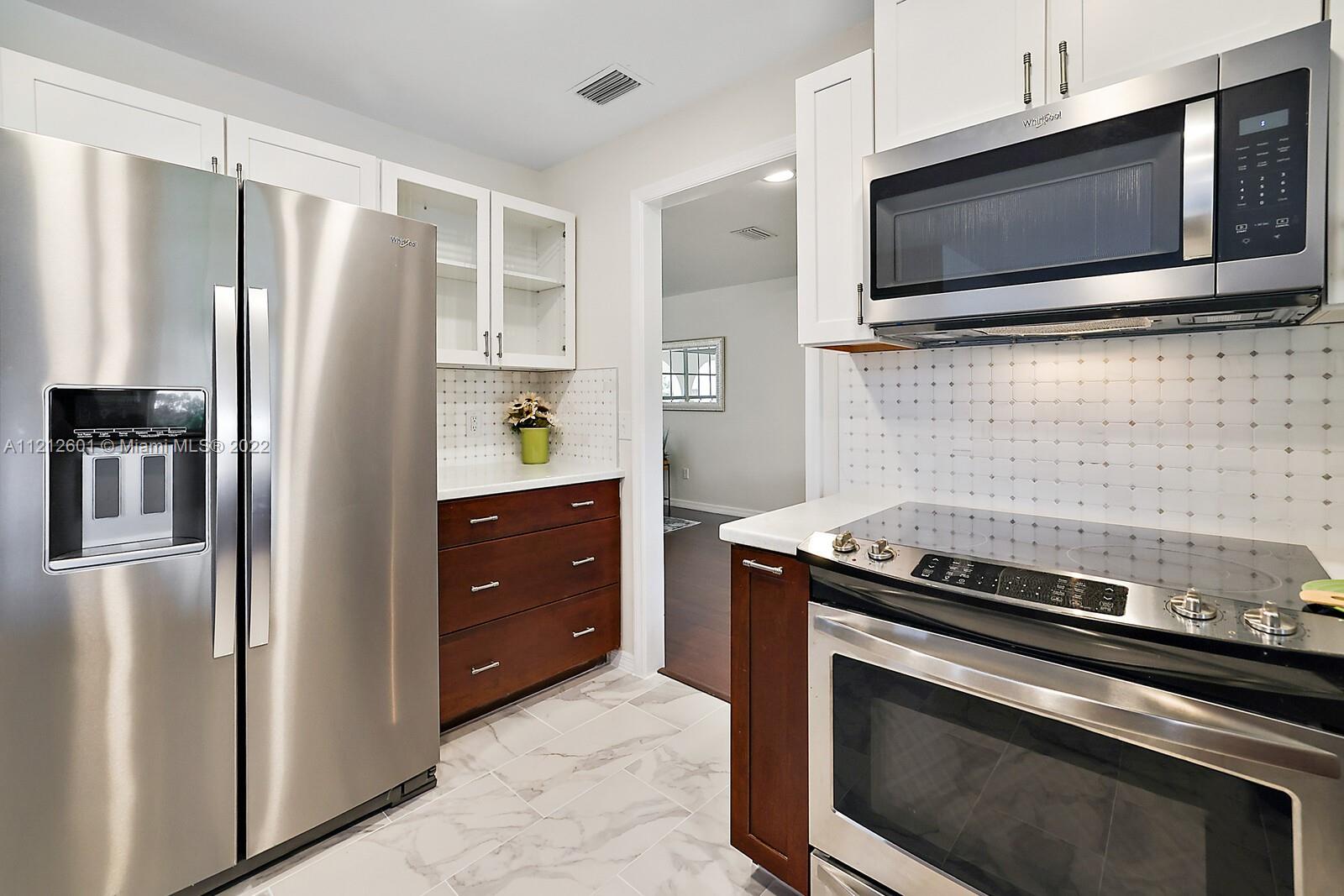 3052 Pine Cove Place Eustis, FL 32726 - Photo 10 of 32 a kitchen with stainless steel appliances and cabinets
