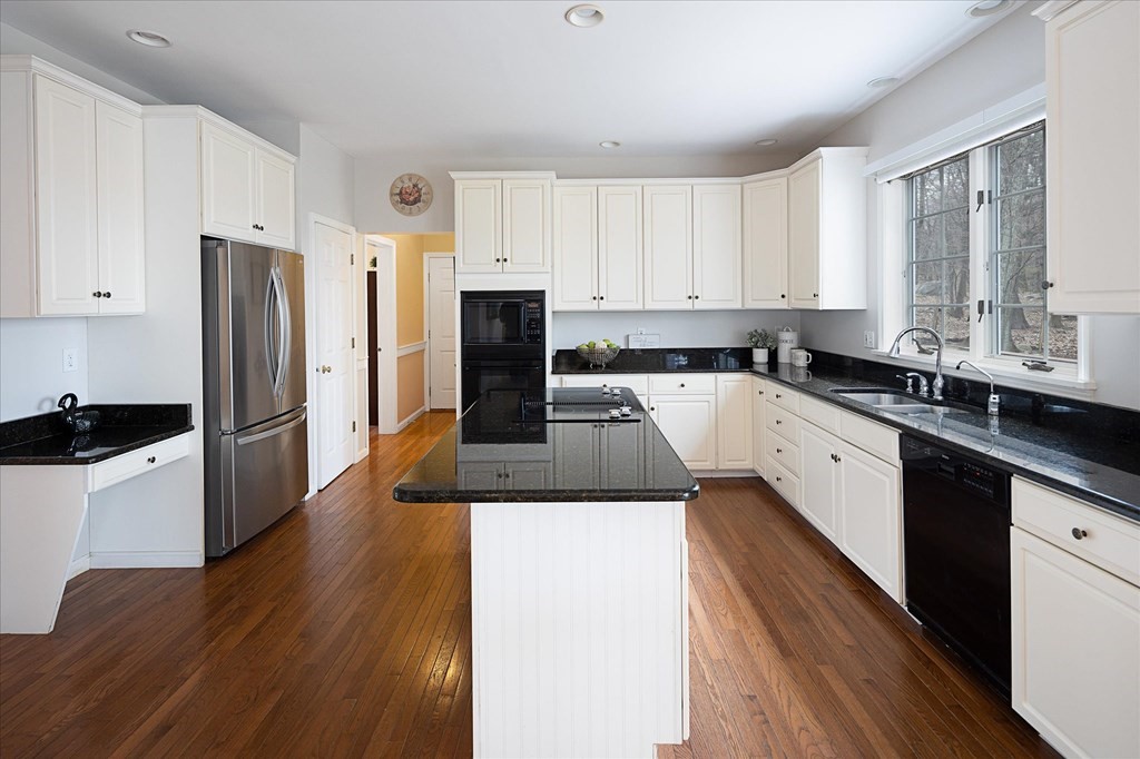 16 Carter Road Shrewsbury, MA 01545 - Photo 15 of 42 a kitchen with a refrigerator a sink and wooden cabinets