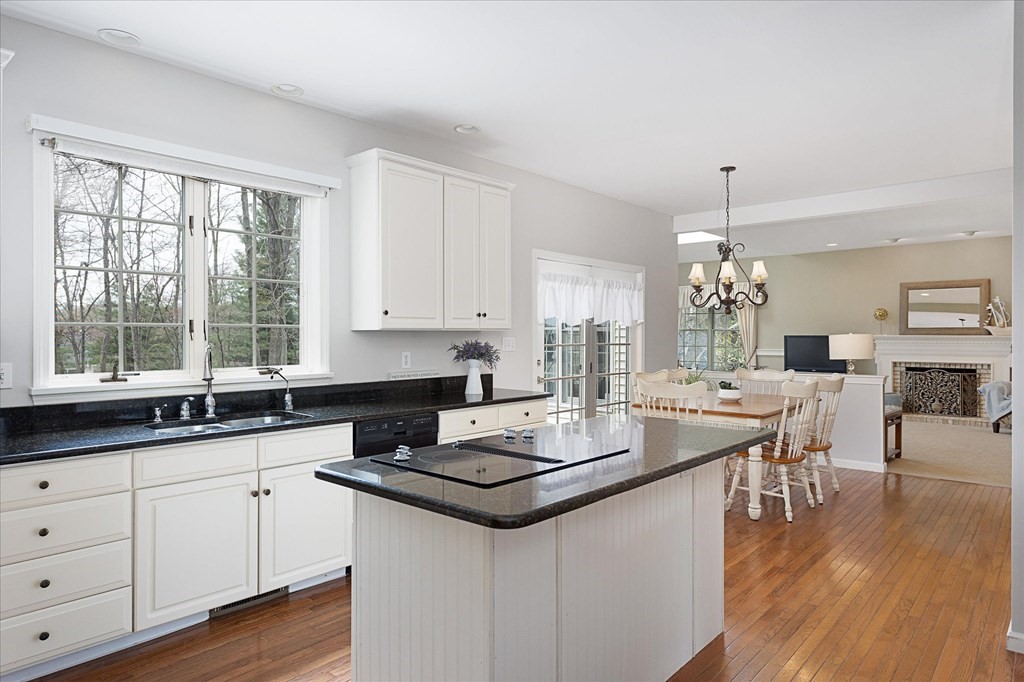 16 Carter Road Shrewsbury, MA 01545 - Photo 16 of 42 a kitchen with granite countertop a stove a sink a dining table and chairs