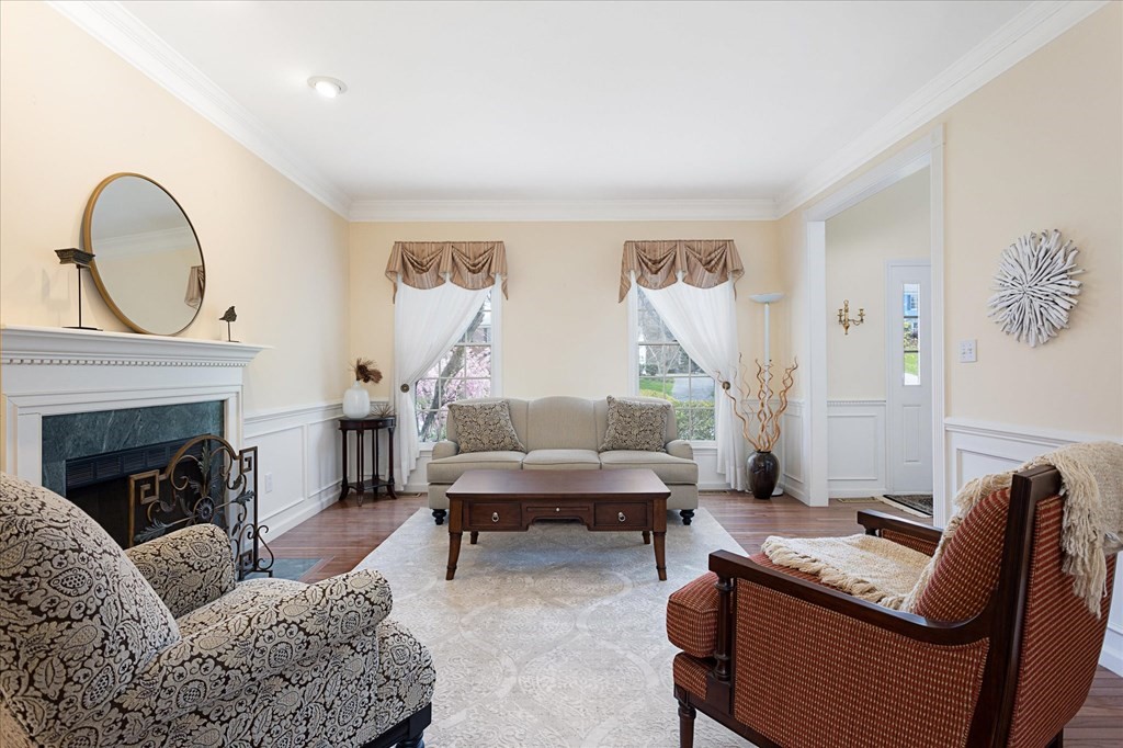 16 Carter Road Shrewsbury, MA 01545 - Photo 6 of 42 a living room with furniture a fireplace and a floor to ceiling window