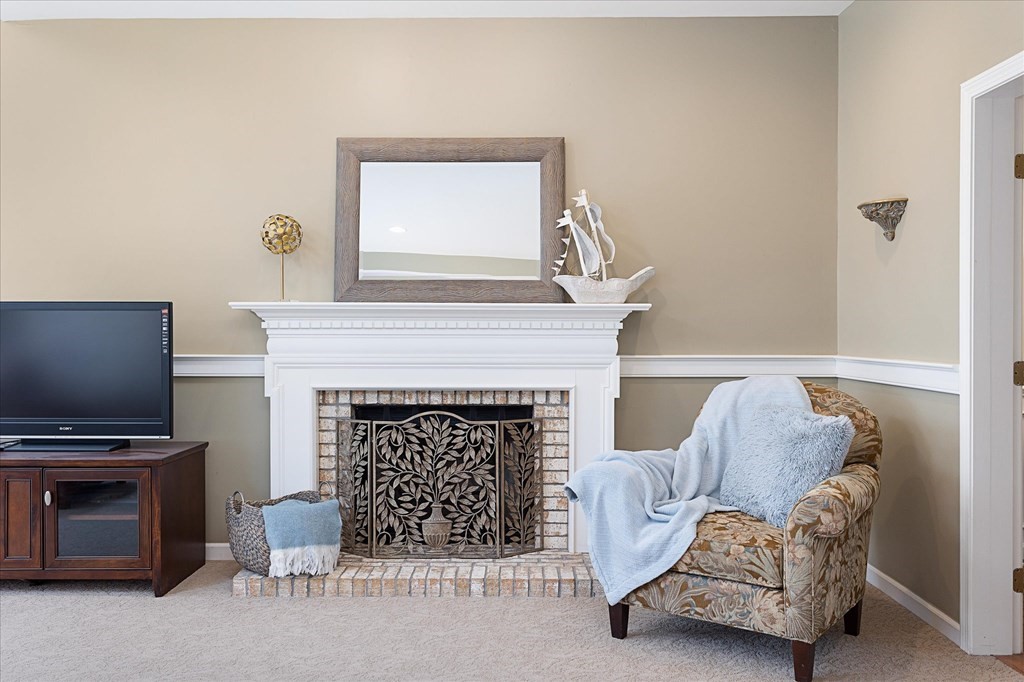 16 Carter Road Shrewsbury, MA 01545 - Photo 8 of 42 a living room with furniture a flat screen tv and a fireplace