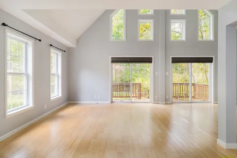 a view of an empty room with large windows
