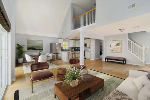 a living room with furniture and a wooden floor