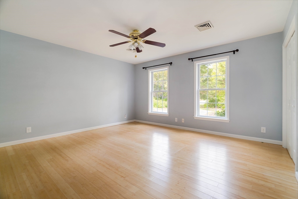 267 Carlisle Road Bedford, MA 01730 - Photo 22 of 32 a view of an empty room with a window and wooden floor