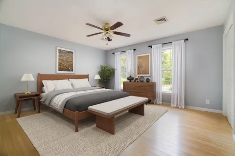 a spacious bedroom with a bed and window