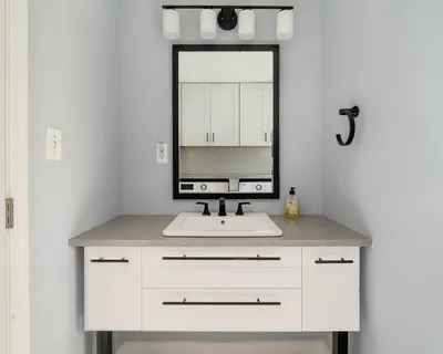 a bathroom with a sink vanity and a mirror