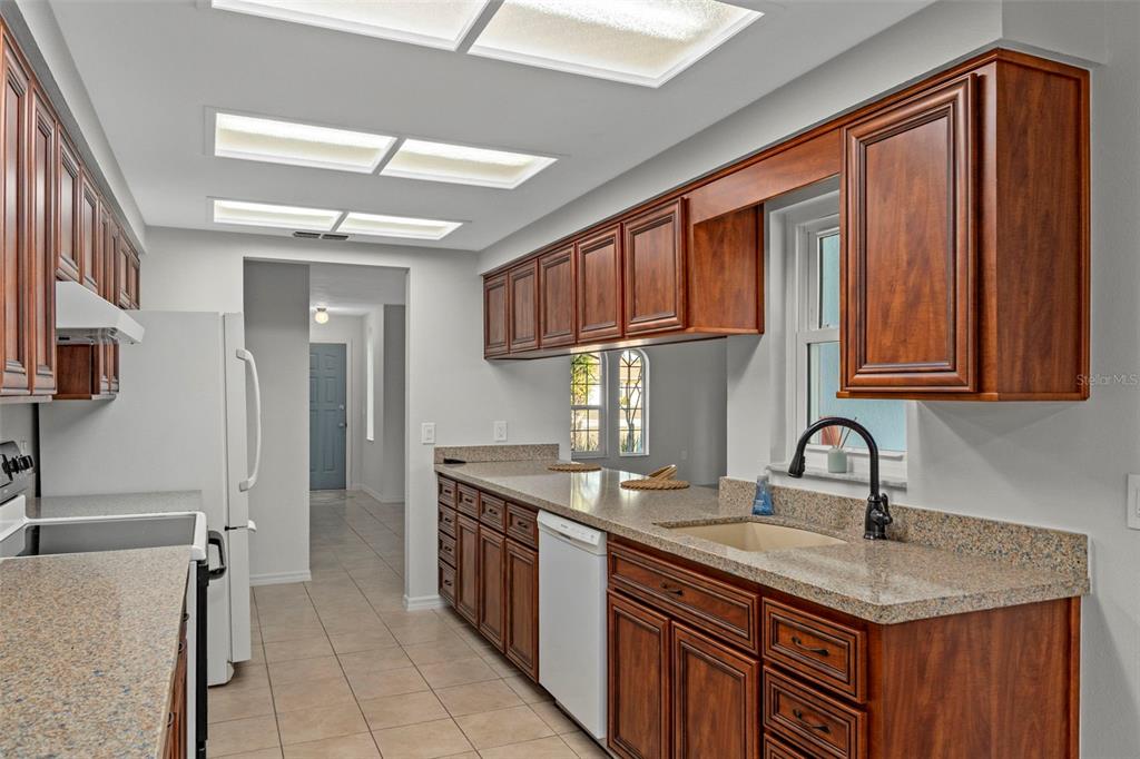 8332 Berkeley Manor Boulevard Spring Hill, FL 34606 - Photo 13 of 47 a kitchen with stainless steel appliances granite countertop a sink stove and cabinets