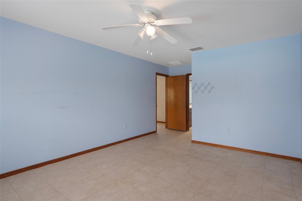 8332 Berkeley Manor Boulevard Spring Hill, FL 34606 - Photo 25 of 45 an empty room with a ceiling fan and a ceiling fan