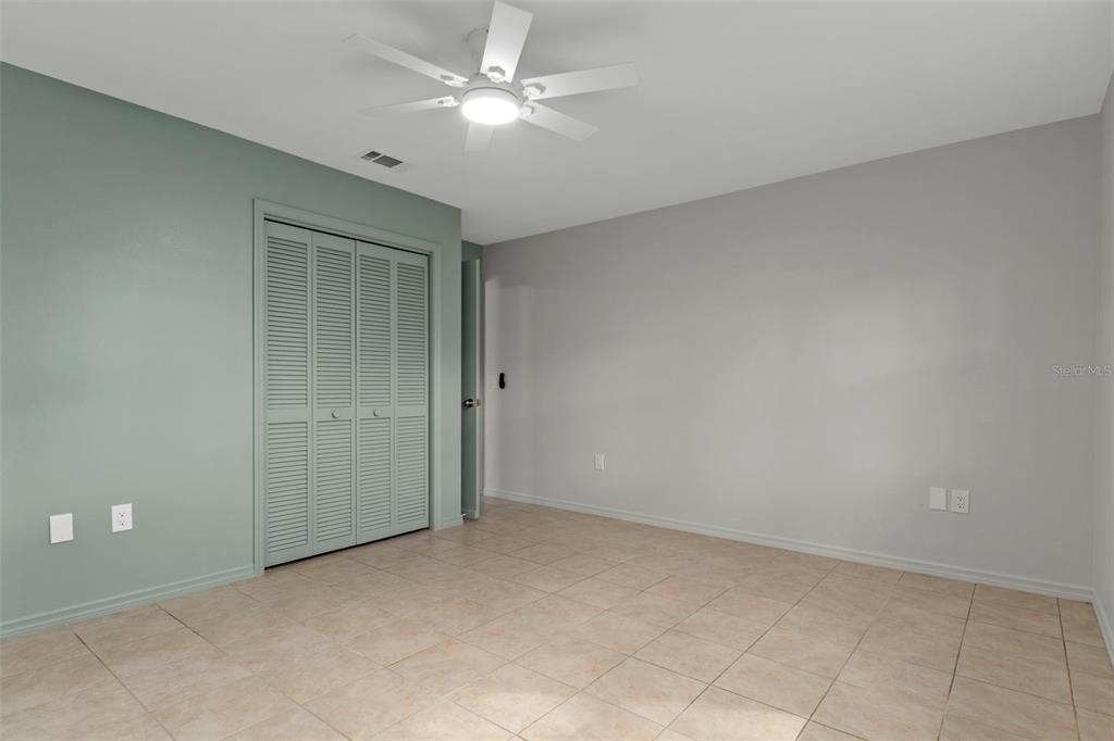 8332 Berkeley Manor Boulevard Spring Hill, FL 34606 - Photo 28 of 47 an empty room with a ceiling fan and a window