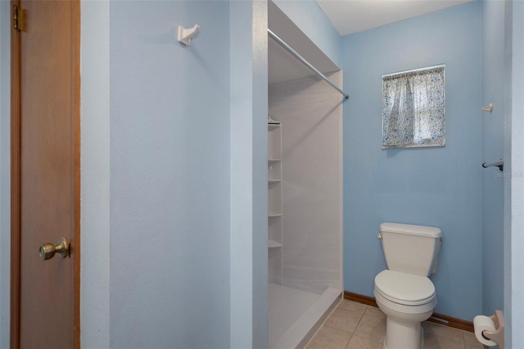 8332 Berkeley Manor Boulevard Spring Hill, FL 34606 - Photo 28 of 45 a white toilet sitting next to a bathroom sink