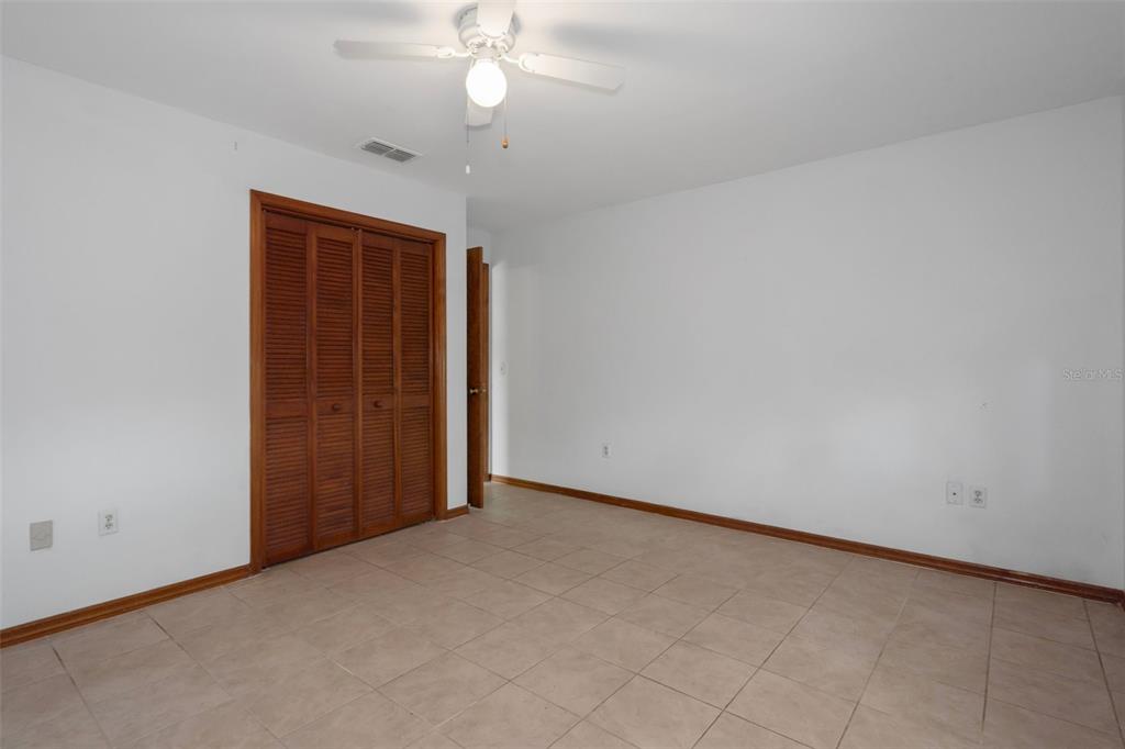 8332 Berkeley Manor Boulevard Spring Hill, FL 34606 - Photo 30 of 45 an empty room with a empty space and a ceiling fan
