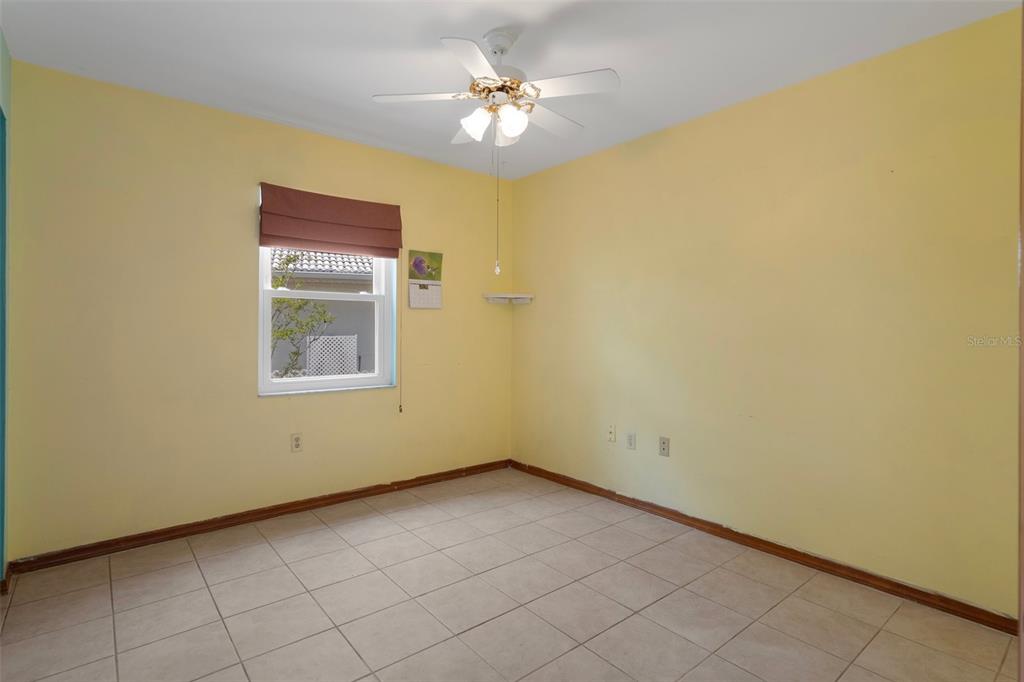 8332 Berkeley Manor Boulevard Spring Hill, FL 34606 - Photo 32 of 45 an empty room with windows and fan