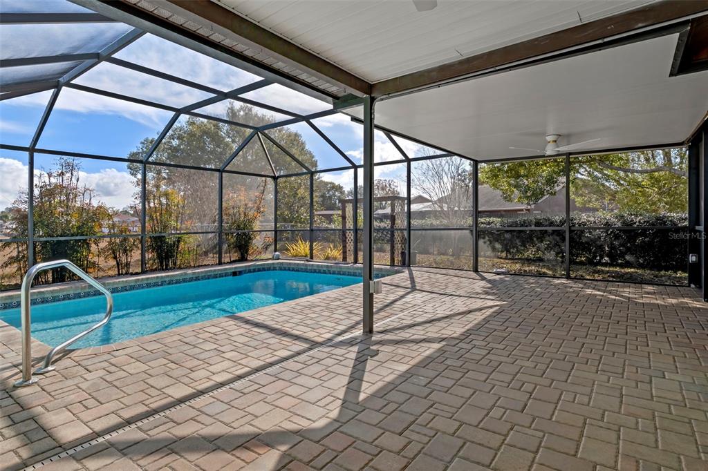 8332 Berkeley Manor Boulevard Spring Hill, FL 34606 - Photo 34 of 47 a view of a swimming pool with a porch