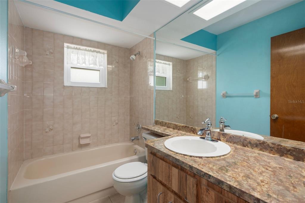 8332 Berkeley Manor Boulevard Spring Hill, FL 34606 - Photo 34 of 45 a bathroom with a granite countertop sink toilet and shower