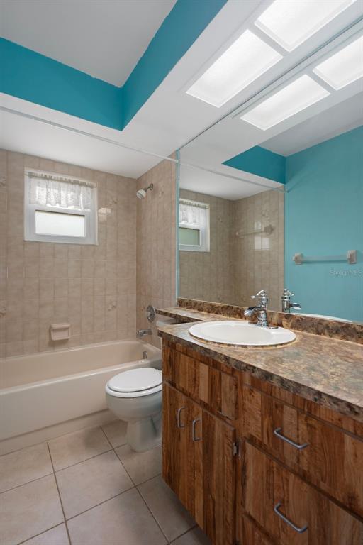 8332 Berkeley Manor Boulevard Spring Hill, FL 34606 - Photo 35 of 45 a bathroom with a granite countertop sink toilet mirror vanity and bathtub