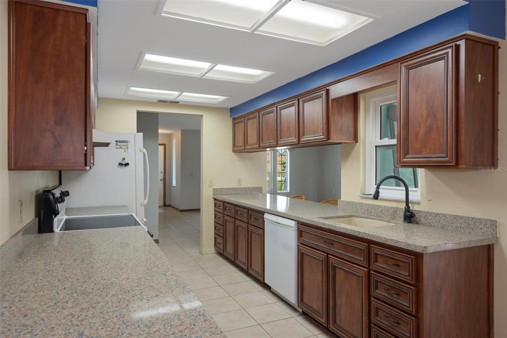 8332 Berkeley Manor Boulevard Spring Hill, FL 34606 - Photo 4 of 45 a kitchen with stainless steel appliances granite countertop a sink stove and cabinets