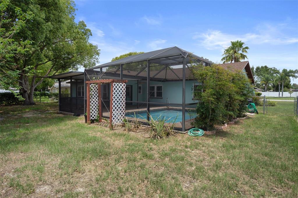 8332 Berkeley Manor Boulevard Spring Hill, FL 34606 - Photo 42 of 45 a view of a house with a yard