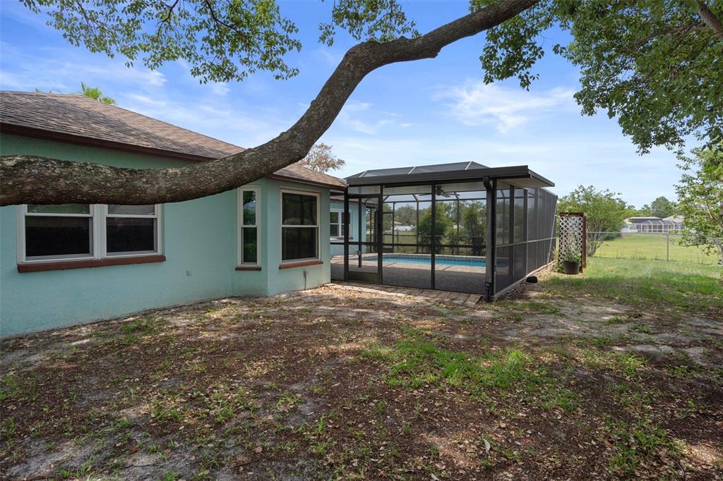 8332 Berkeley Manor Boulevard Spring Hill, FL 34606 - Photo 44 of 45 a view of an house with backyard space and balcony