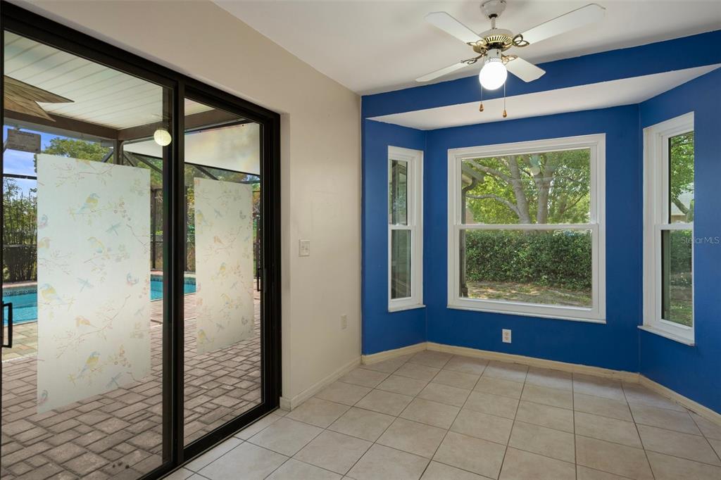8332 Berkeley Manor Boulevard Spring Hill, FL 34606 - Photo 5 of 45 a view of an empty room with window and chandelier fan